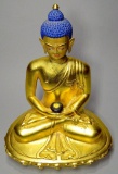 Tibetan Bronze Gilt Sitting Buddha with Blue Hair, Headdress, and Black Jar