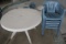 White plastic patio table w/ 5 blue plastic chairs