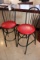 Black frame bar chair with red padded seat