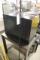 Metal file cabinet, floor lamp, wood table