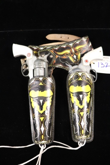 Pair to go -  Hubley Cowboy cap guns with holsters