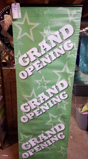 Black metal hanger stand with Grand opening banner