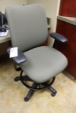 Green tweed office chair with arm rests