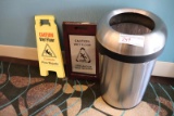 Stainless trash can with two wet floor signs