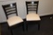 Times 20 - Black wood framed ladder back dining chairs with tan vinyl seats