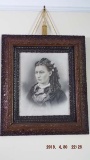 Portrait with ornately carved frame