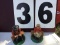 Pair of metal figurines, man & woman sitting, appear to be 