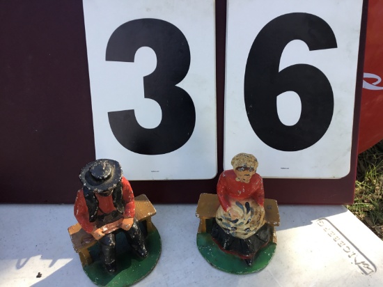 Pair of metal figurines, man & woman sitting, appear to be "Amish" type, approx. 5" tall