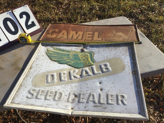 Group of 2 metal signs - Camel 12" x 32" (rusted), Dekalb Speed Dealer 23" x 29" (minor damage)