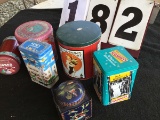 Various decorative metal tins; includes Hershey Kisses, tea, Raisinets, etc.