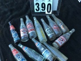 Group of old glass soda bottles including Big Boy Cola, Pepsi, Lotta Cola, Double Cola