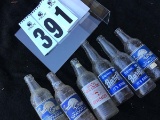 Group of old glass soda bottles including Sun Crest, Barq's Root beer, Old Colony Beverages