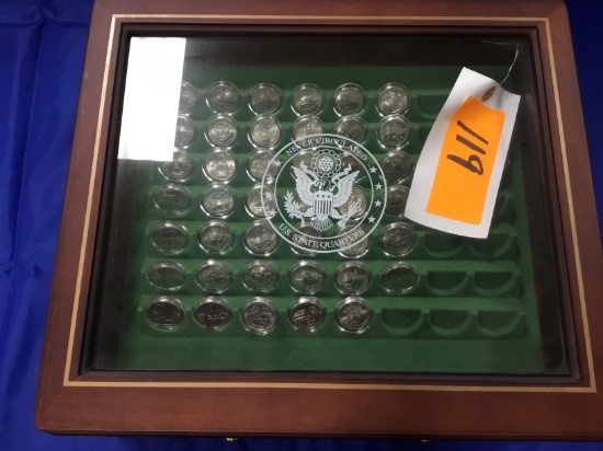 "Never Circulated US State Quarters" in wood, glass top display box with one drawer containing never