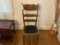Oak dining room chair; vintage w/decorative cardboard type material bottom; ladder back; 42