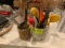 Two pottery crocks filled w/kitchen utensils including potato masher, wood hammer, wood spoons, plas