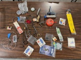 Group of fishing tools, new steel leaders, swivels, and advertising matchbo