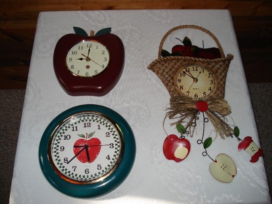 Assorted apple themed wall clocks