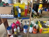 Middle and bottom shelf of misc cleaners,wipes,rags,sprayers