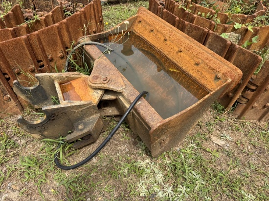 mini excavator digging or trenching bucket equipped with a quick-attach coupler pin mount