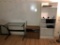 LOT CONSISTING OF GLASS TOP DESK AND 2 WOODEN SHELF UNITS