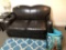 BROWN LEATHER LOVE SEAT WITH (3) PILLOWS