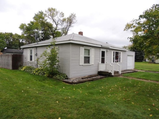 Lot 1: 406 4th St SE.  28x32 house with gray vinyl siding and attached 12x2