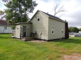 Lot 3: 410 4th St SE.  1.5 Story House with vinyl windows, green vinyl sidi