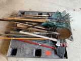 Pallet of forks, shovels, rakes, brooms