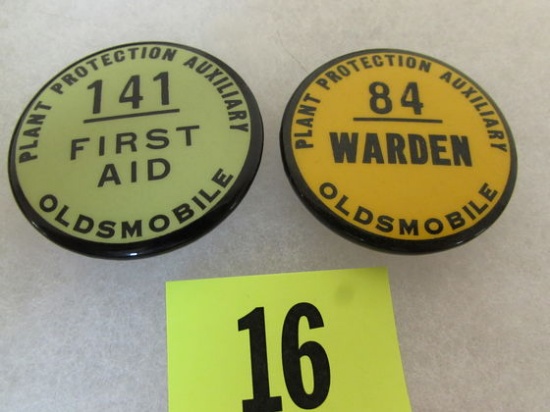 (2) Vintage Oldsmobile Plant Protection Badges (warden, First Aid)