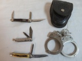 Vintage Smith & Wesson Hand Cuffs and (3) Folding Knives Inc. Sabre, Ulster, and Powerkraft