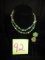 Green beaded necklace and clip earrings