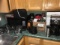 Microwave, coffee amker, supplies on counter