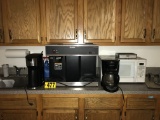 Countertop contents: Bunn coffee maker, microwave