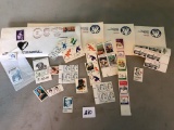 Postage paid envelopes and assorted stamps