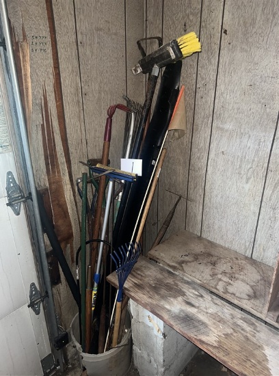 Assorted garden tools, brooms, rakes, hoes (in corner)