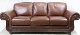 BROWN LEATHER THREE CUSHION SOFA