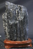 LARGE BLACK TOURMALINE ON WOOD STAND