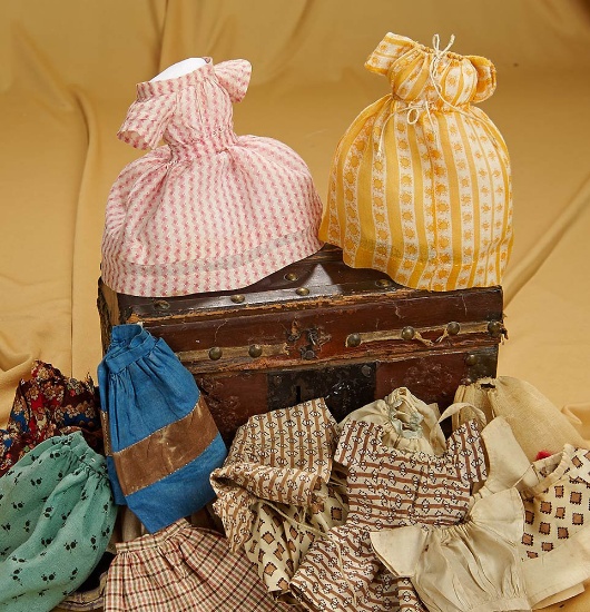 9" x 4" x 5" Early wooden domed trunk with costumes for early miniature doll. $400/600