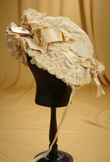 "Edith's Baby Bonnet" of ivory silk and lace. $400/500