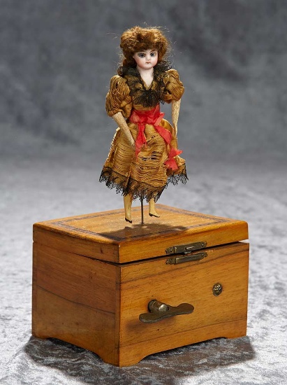 11"h. Swiss wooden cased music box with dancing bisque doll. $1200/1400