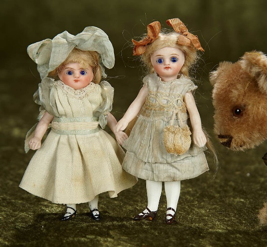 Two 4 1/2" German all-bisque miniature dolls in antique costumes. $400/500