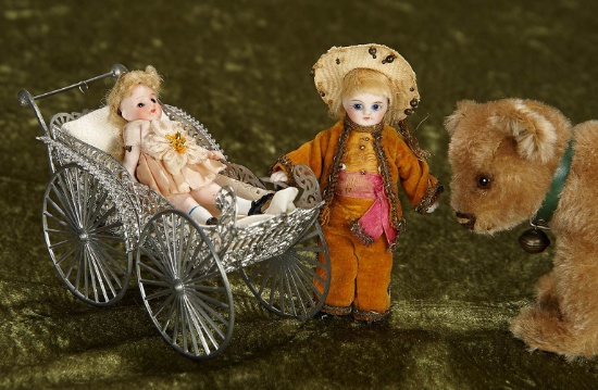 3 1/2" - 4". Two German all-bisque miniature dolls and filigree silver carriage. $400/500