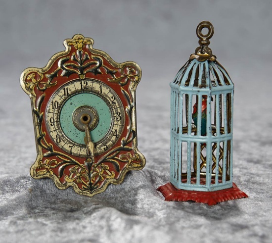Two 3" German tin miniature "penny toys" including clock and bird cage. $400/500
