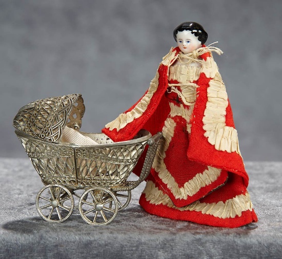 4"German porcelain lady doll with original costume, and filigree baby carriage.$300/400