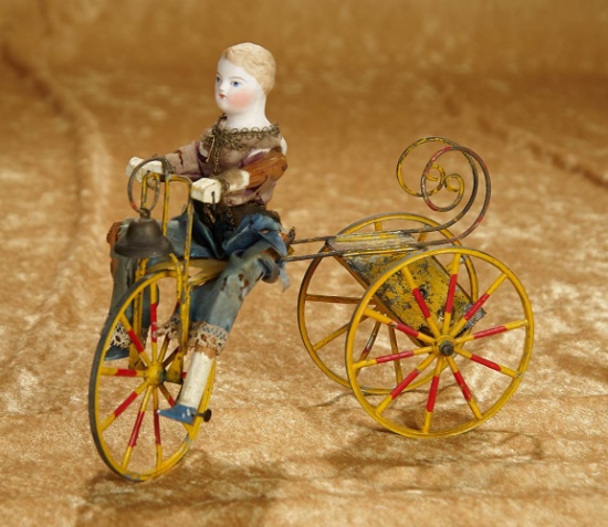 9 1/2" French mechanical toy "Young Lad Riding a Velocipede". $600/900