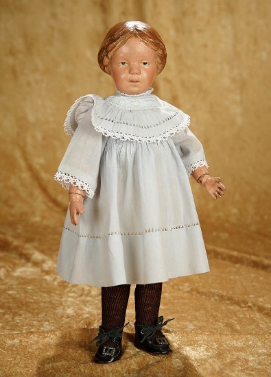 14" American wooden doll, model 102, by Schoenhut with carved hair and blue bow. $800/1100