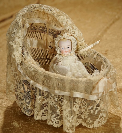 5" German all-bisque baby in beautiful antique gown, with lace-fitted layette. $300/500