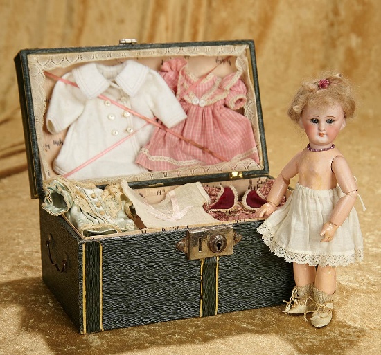 8 1/2" Petite bisque doll. model 749, for the French market with trunk and trousseau. $800/1100