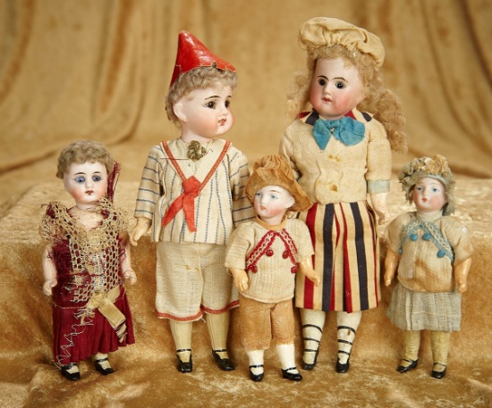 Five 5"-8" German bisque dolls in factory original costumes. $700/900