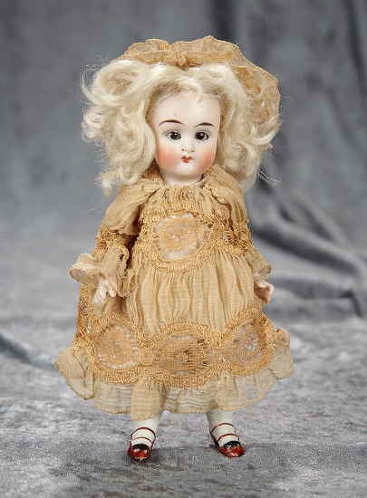 6" German all-bisque miniature doll with brown glass eyes. $200/300